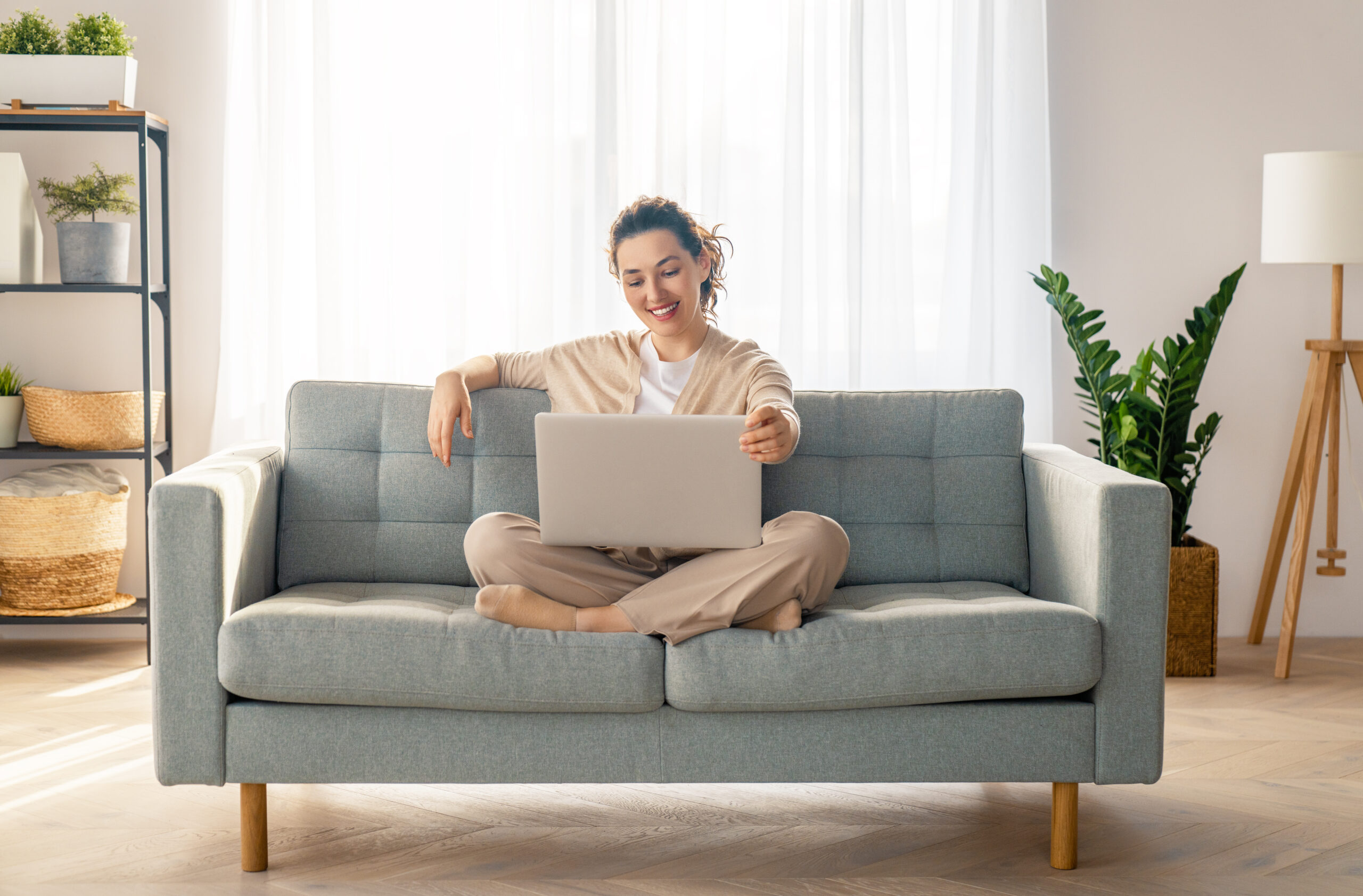 Woman using laptop on couch