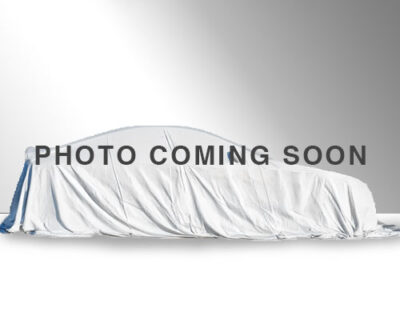 Vehicle with white sheet covering it, text reads coming soon